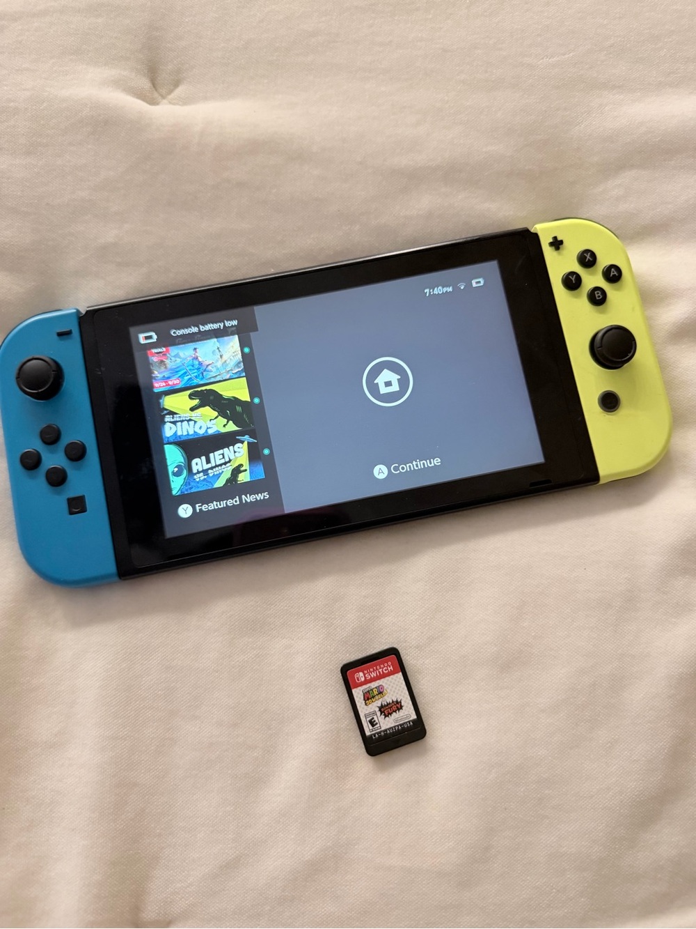 Nintendo Switch with Blue Left and Neon Yellow Right Joy‑Con